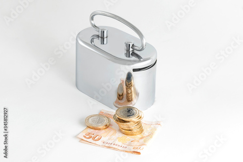 Silver metal money box, Turkish Lira banknote and coins.