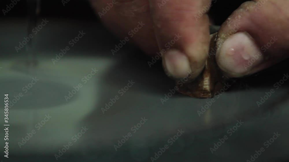 Extreme close-up of lab testing a metal ingot. Filing the ingot on a rotating horizontal filing plate Extreme close-up of lab testing a metal ingot. Filing the ingot on a rotating horizontal filing plate