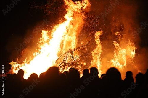 People watching a large fire (silhouette)