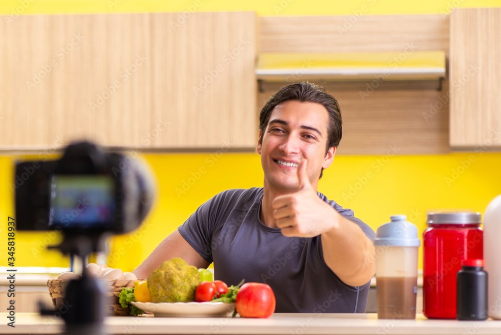 Young man blogging about food supplements Young man blogging about food supplements