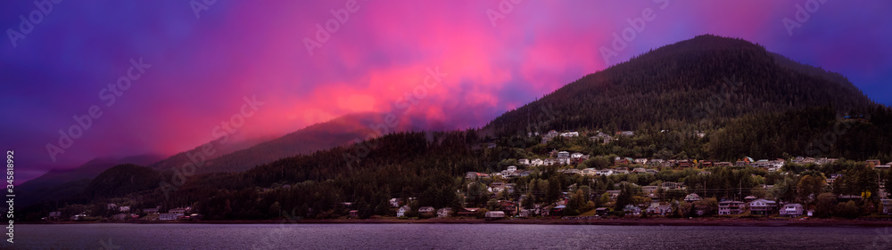 Beautiful Panoramic view of a small town, Juneau, during a cloudy morning with mountains in the background. Taken in Alaska, United States. Colorful Artistic Sky Composite