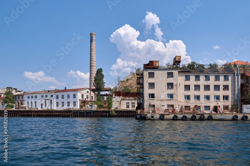 Obraz na płótnie Sevastopol - August 9, 2016: Industrial factory territory, brick pipe, view from the sea w salonie