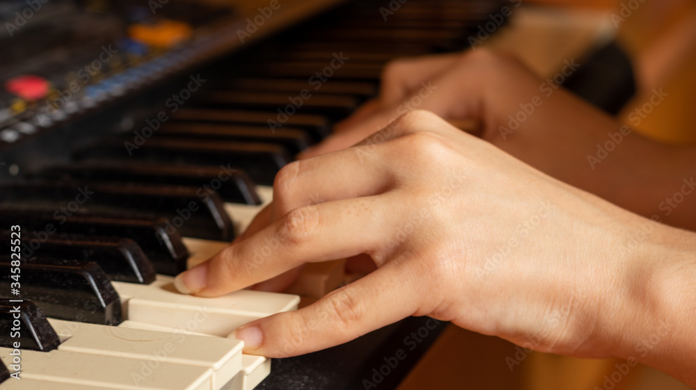 Fototapeta premium A hands playing with a piano