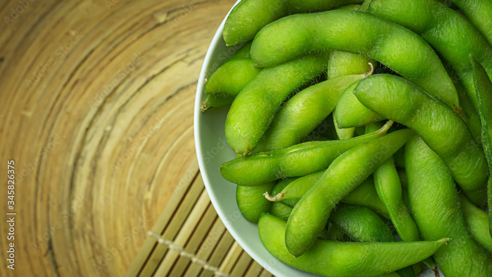 Edamame in white bowl top view image for food content. Edamame in white bowl top view image for food content.