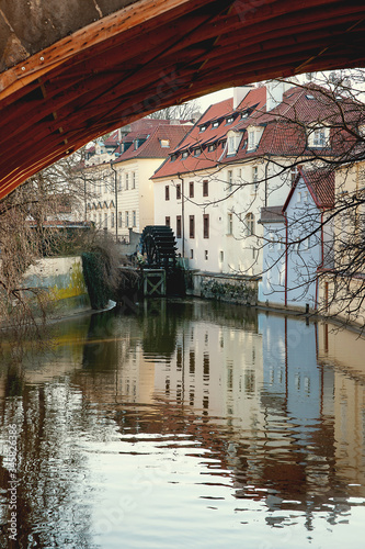 The old medieval mill-wheel on Chertovka channel in Mala Strana. Prague photo