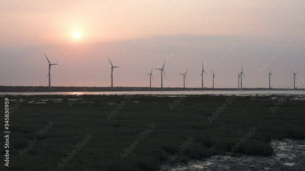 wind turbine farm at Gaomei wetlands landscape during sunset, Taichung, Taiwan wind turbine farm at Gaomei wetlands landscape during sunset, Taichung, Taiwan