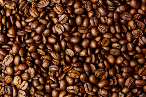 Roasted coffee beans close up background 