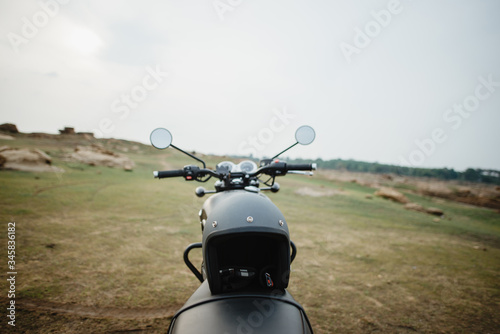 Helmet and vintage motorcycle blur background
