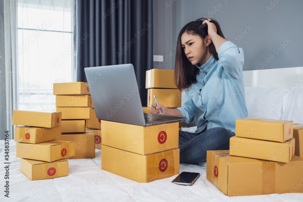 stressed woman using laptop computer and working problem to selling product online on bed at home stressed woman using laptop computer and working problem to selling product online on bed at home