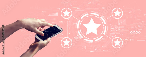 Rating star concept with person holding a white smartphone