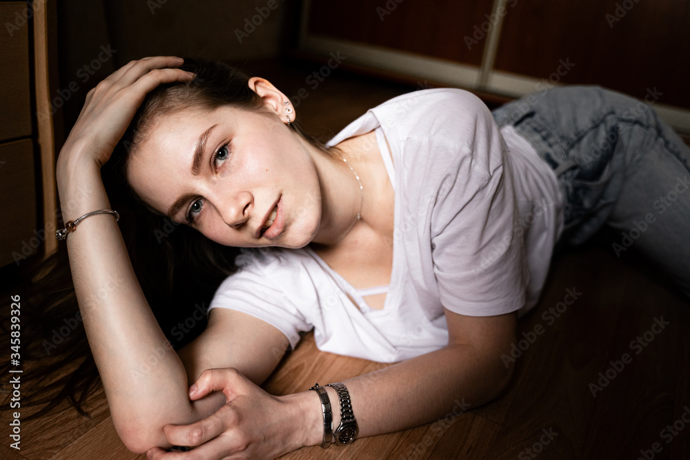 girl lying at home on the floor looking at the camera
girl lying at home on the floor looking at the camera