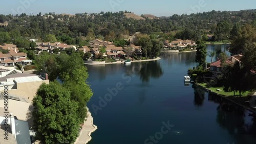 Drone flyover Calabasas lake and homes of rich and famous, daytime photo