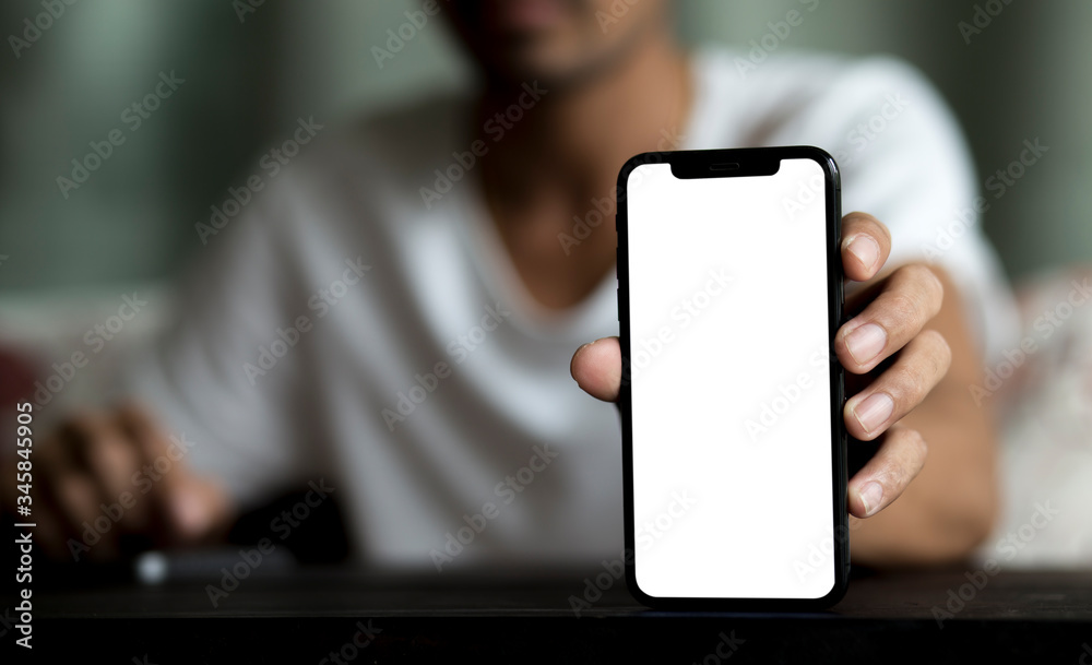 Man holding smartphone with white screen and using smartphone background during stay at home Man holding smartphone with white screen and using smartphone background during stay at home