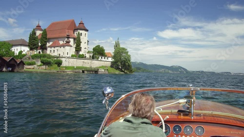 POV WS Motorboat on Traunsee lake with view of church housing Fischerkanzel photo