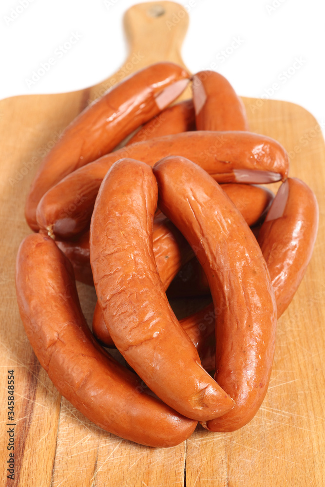 Smoked sausages on cutting board Smoked sausages on cutting board