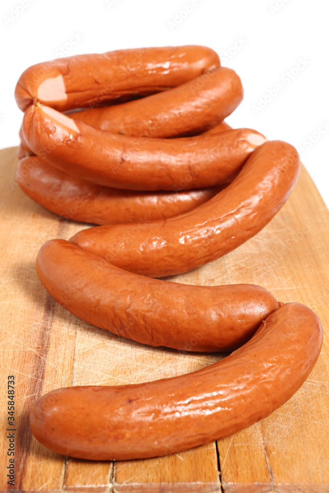 Smoked sausages on cutting board Smoked sausages on cutting board