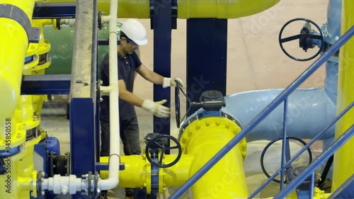 WS Worker turning valve in water treatment plant