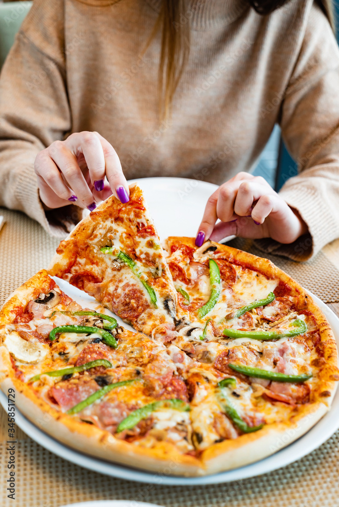 woman eating italian pizza in cafe