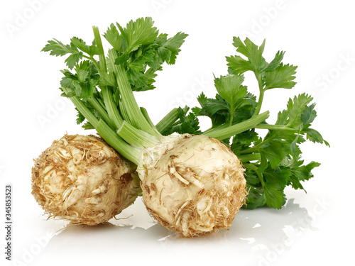 Fresh celeriac root with celery stalks isolated photo