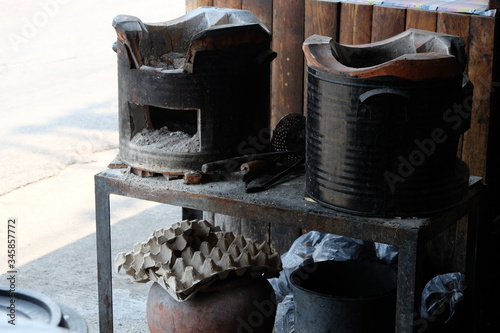 The old kitchen equipment of the restaurant on the sidewalk of the Thai people.