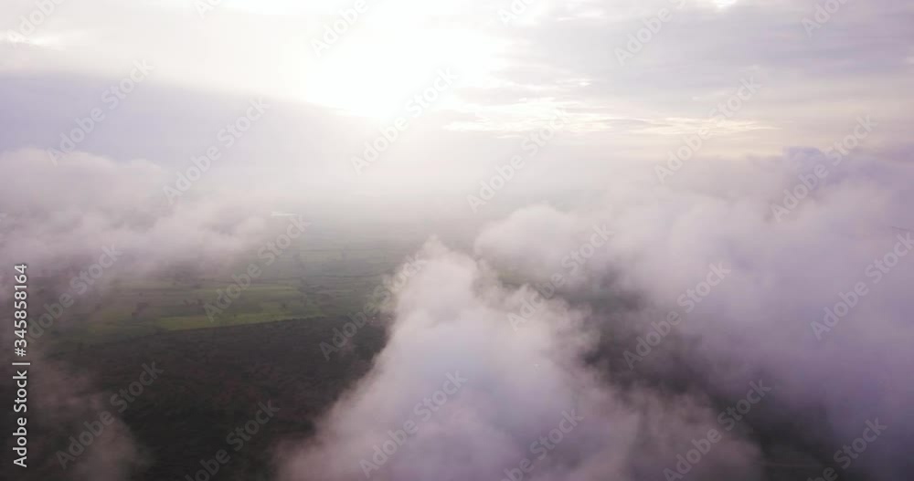 Aerial view above white bed of clouds at sunset. Aerial view above white bed of clouds at sunset.