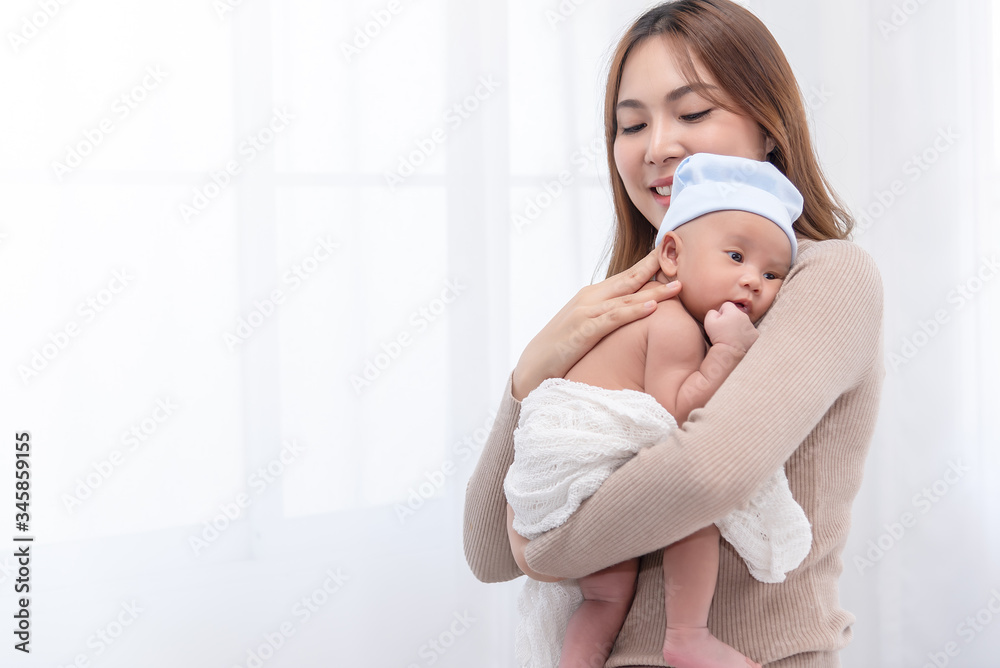 Close up beautiful young asian mother holding her newborn one month baby sleep on her shoulder. Healthcare and medical. Lovely asian woman lifestyle mother's day concept. Close up beautiful young asian mother holding her newborn one month baby sleep on her shoulder. Healthcare and medical. Lovely asian woman lifestyle mother's day concept.