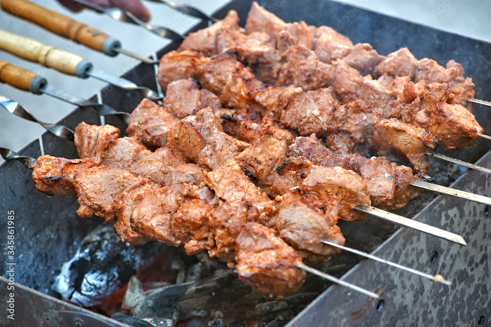 Cooking delicious pork shish kebab on the grill