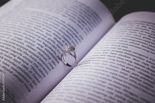 Modern and beautiful ring set on book. Jewelry product photography.