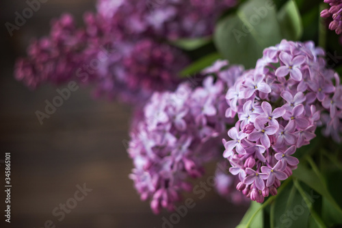 Bouquet of lilac on a background of brown wooden background. Spring beautiful lilac flowers  background.