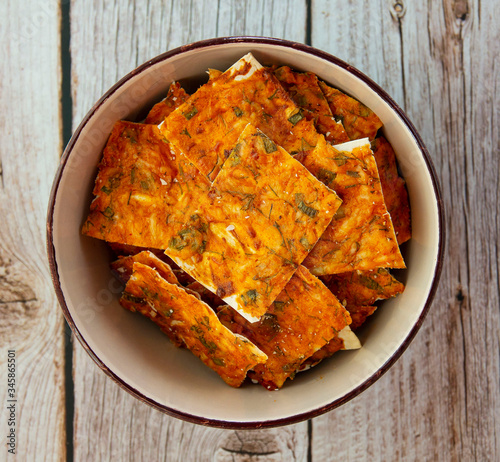 Homemade chips with cheese and herbs