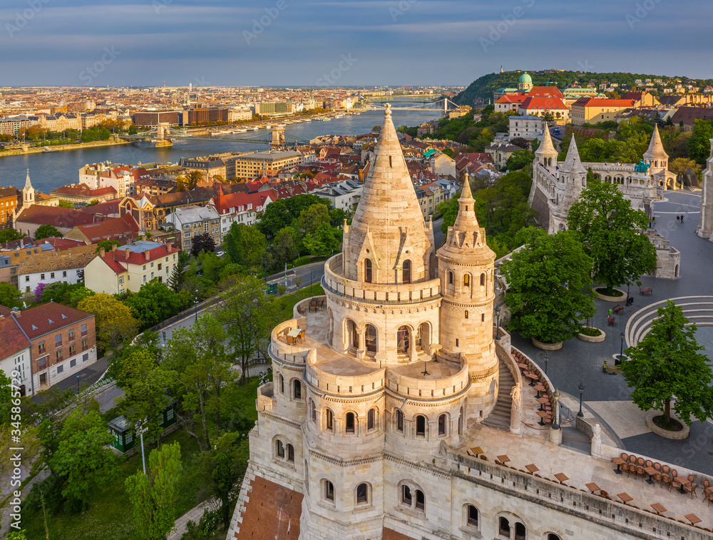Budapest, Hungary - Aerial view of the famous Fisherman's Bastion at sunset with Szechenyi Chain Bridge, Elisabeth Bridge and Buda Castle Royal Palace at background on a sunny summer afternoon