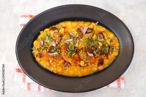 Indian Food-Ragda Pattice is popular street food of India. Ragada is a curry made of yellow vatana & pattice is made of potatoes along with spices. garnished with Sweet & mint chutney, chopped onions.