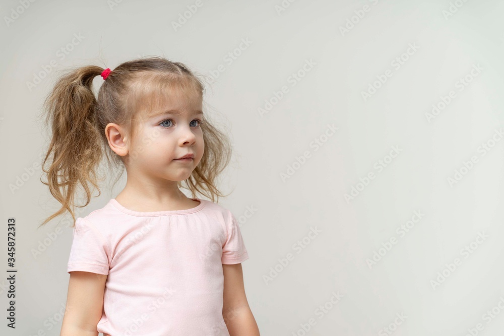 beautiful girl stands against a white wall beautiful girl stands against a white wall