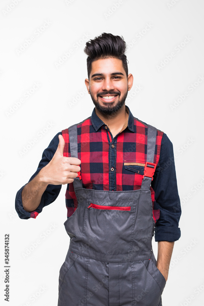 Fototapeta premium Smiling indian man worker thumbs up on white background