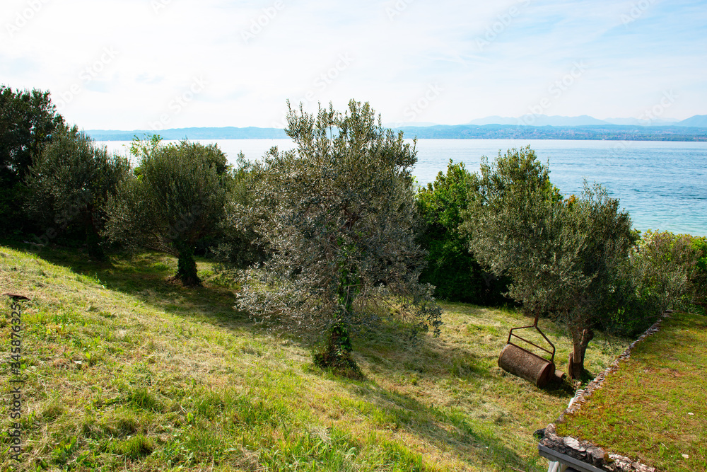 Landscape with blue sky, mountains and transparent blue turquoise water in lake Garda, Sirmione del Garda, Italy, Europe. Peaceful place Landscape with blue sky, mountains and transparent blue turquoise water in lake Garda, Sirmione del Garda, Italy, Europe. Peaceful place