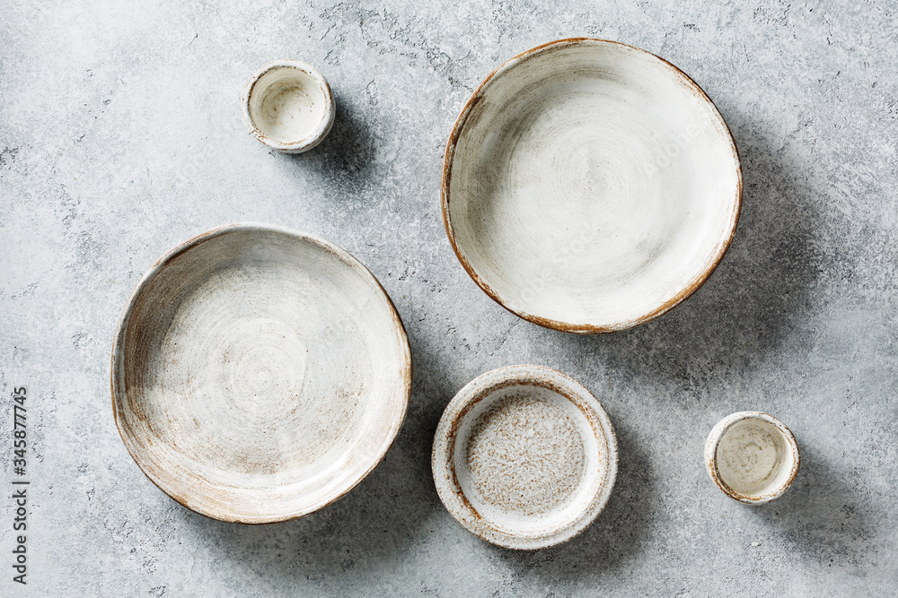 Tableware set of ceramic on a stone dark background. Top view. Tableware set of ceramic on a stone dark background. Top view.