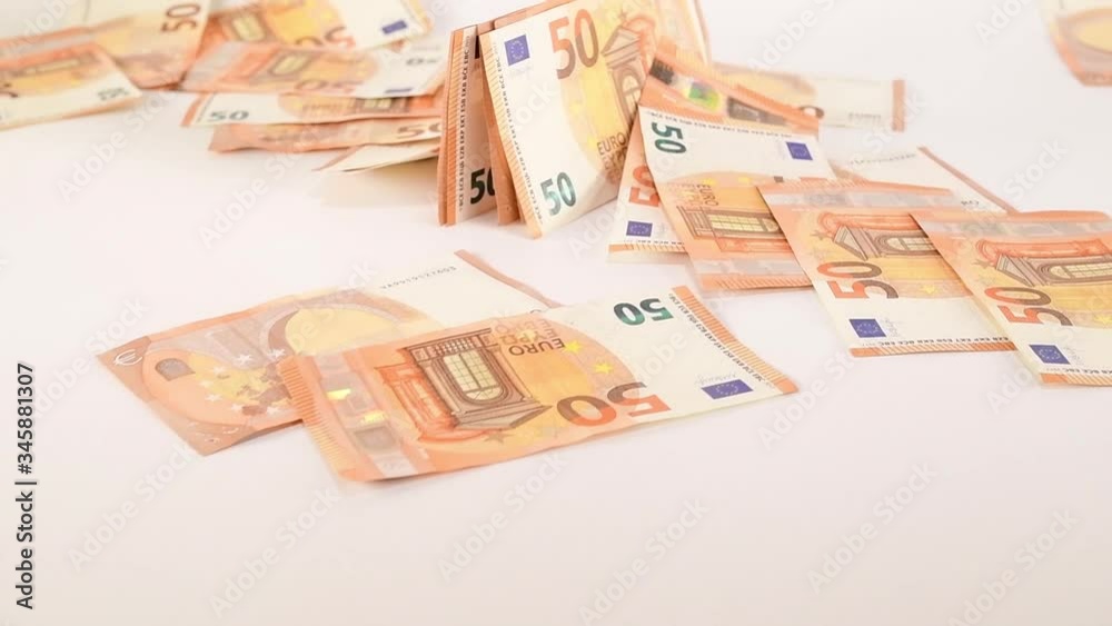 Slow motion of euros are flying and falling. Banknotes of 50 values fly and drop on a white background. financial crash concept Slow motion of euros are flying and falling. Banknotes of 50 values fly and drop on a white background. financial crash concept