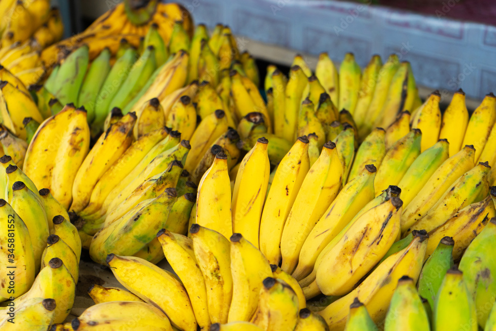 A counter with branches of yellow bananas. A counter with branches of yellow bananas.