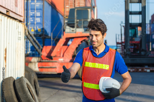 Cheerful factory worker man smiling with giving thumbs up as sign of Success