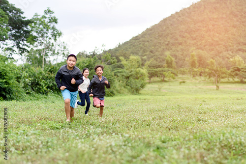 Young boy and girl running on a field