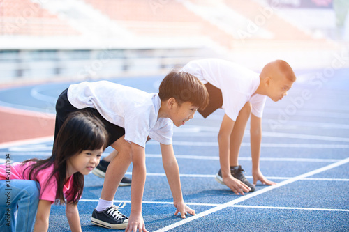 Young boy and girl prepare to start running