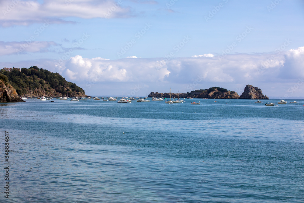  Fishing boats and yachts moored in the bay at high tide in Cancale, famous oysters production town. Brittany, France,