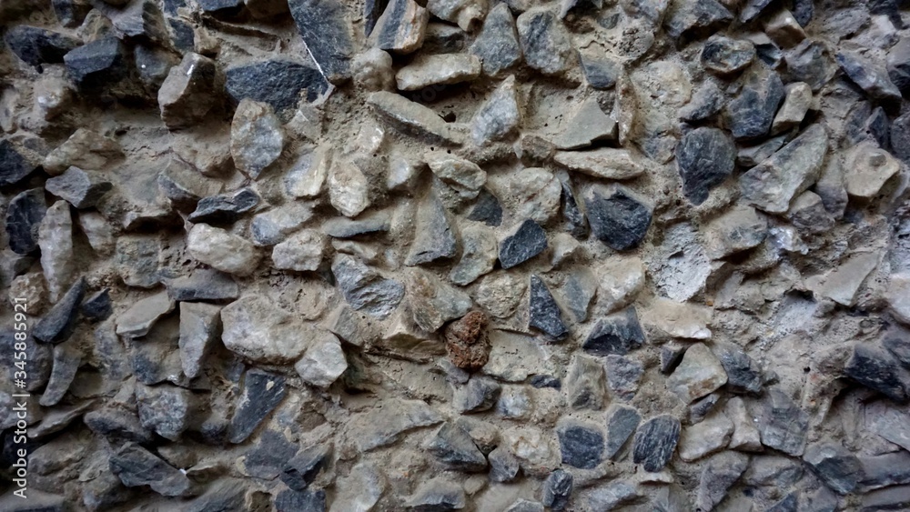 Old gray small stones on the wall Old gray small stones on the wall