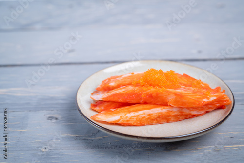 Crab sticks on the plate that is on the table