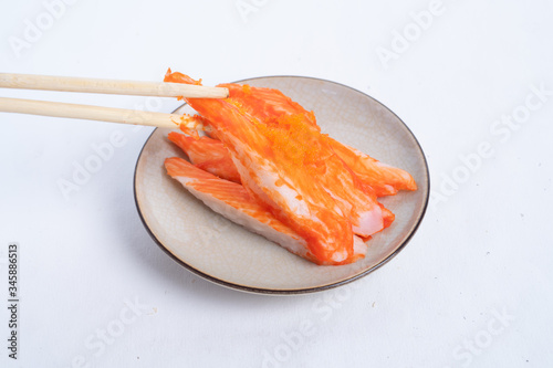 Crab sticks on the plate that is on the table
