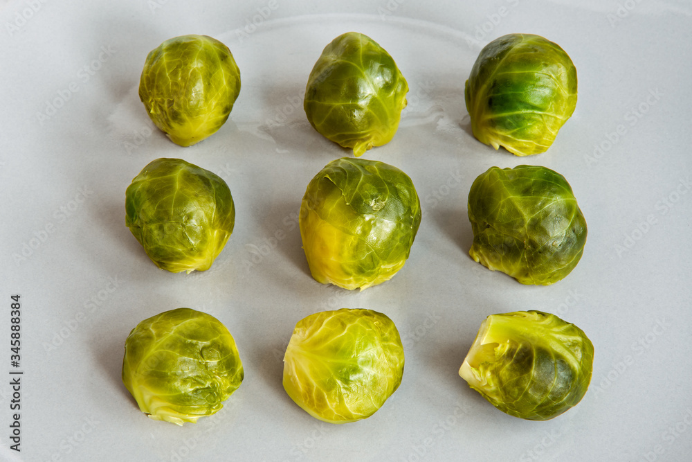 Delicious nine pieces of cooked brussel sprouts. Boiled vegetables on grey plate for dinner, lunch or snack. Selective focus. Delicious nine pieces of cooked brussel sprouts. Boiled vegetables on grey plate for dinner, lunch or snack. Selective focus.