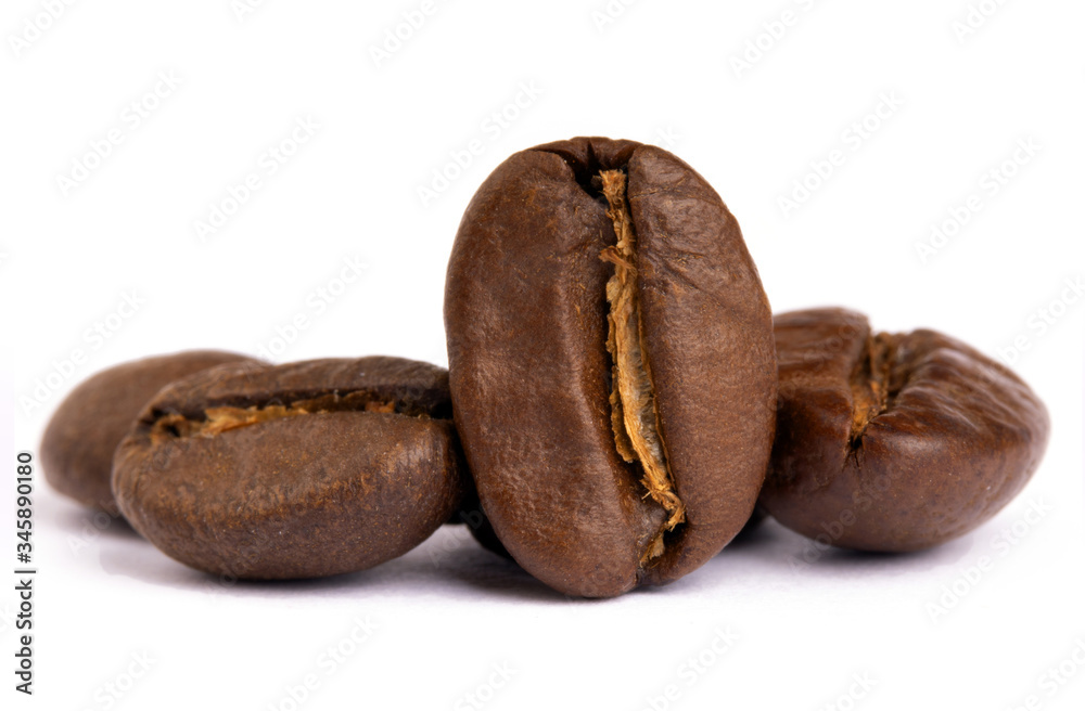 Roasted coffee bean closeup, selective focus, isolated on white Roasted coffee bean closeup, selective focus, isolated on white