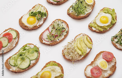 Sandwiches with healthy vegetables and micro greens on colorful background.