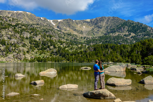 Hikers at the Malniu Lake (Cerdanya province, Catalonia, Spain)