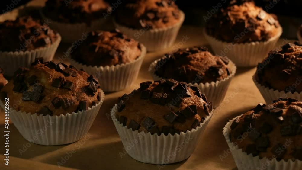 Delicious muffins in paper molds are cooked in the oven close up view